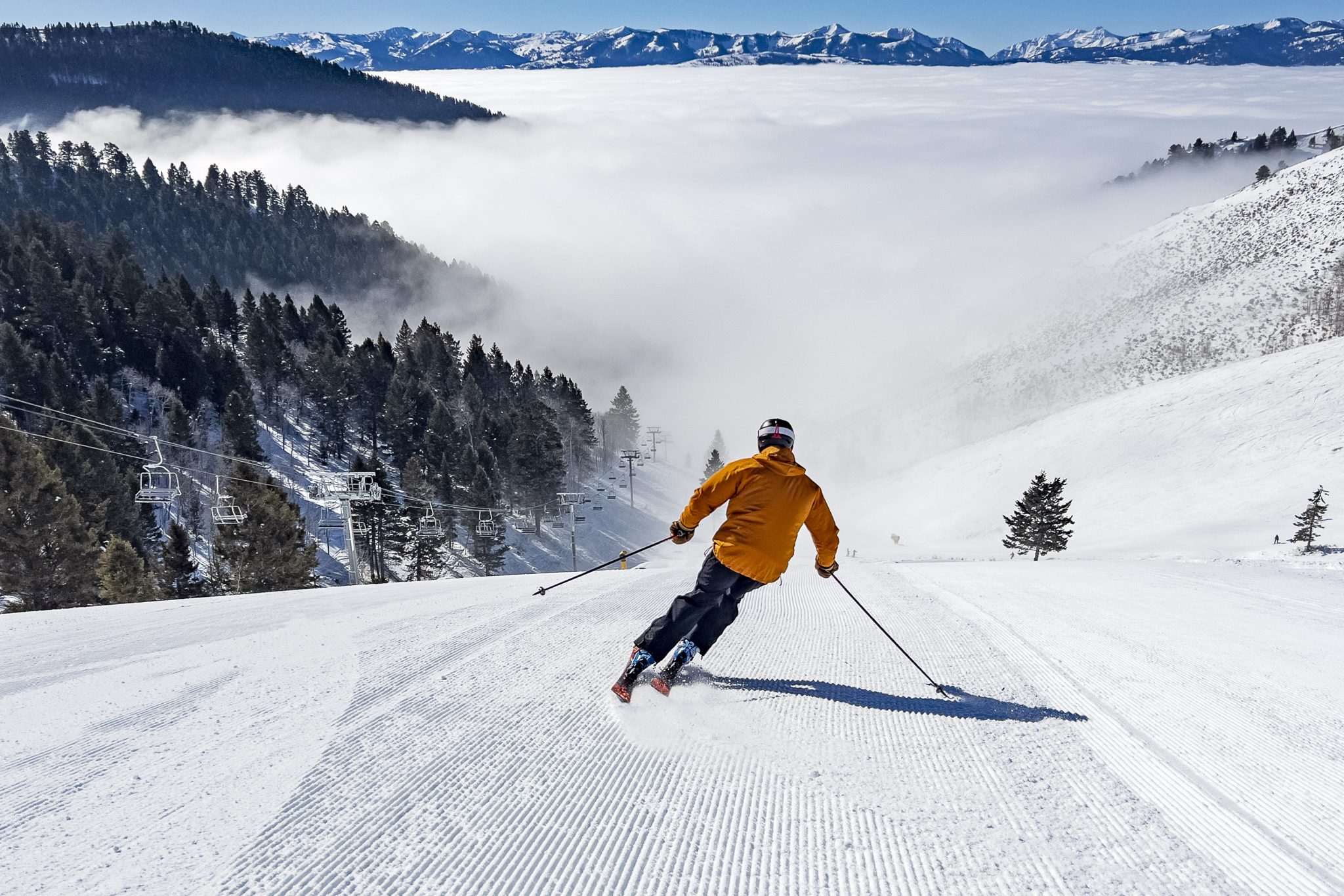 January 31, 2024 - Jackson, WY: Ed Wiand skiing the Sun Bowl at Snow King Mountain on a day with a strong inversion maintaining a fog layer known as the sea of dreams.